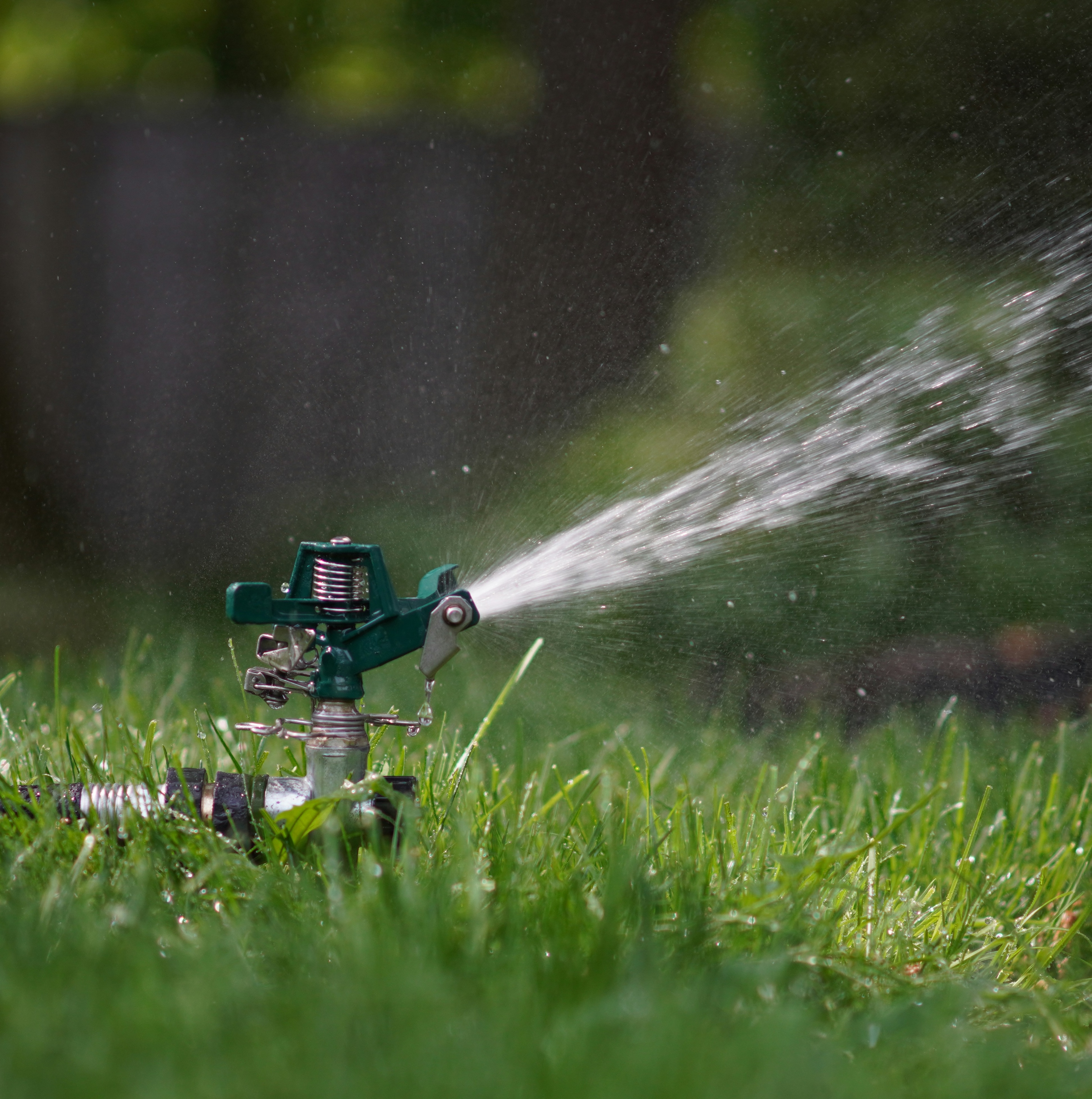 Photo of a sprinkler in grass, by Paul Moody on Unsplash.com