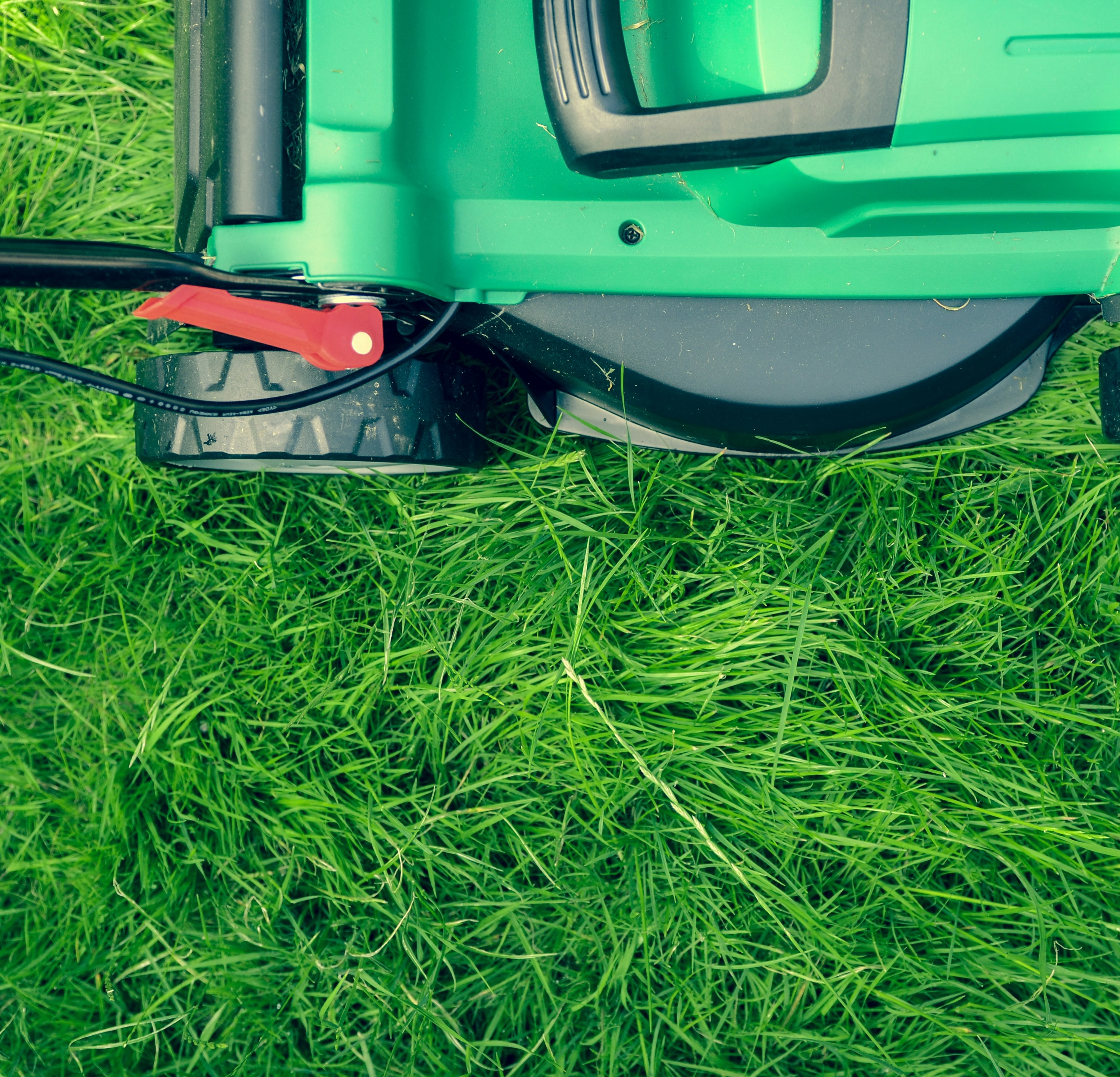 Photo of a lawnmower in grass, by Daniel Watson on Unsplash.com